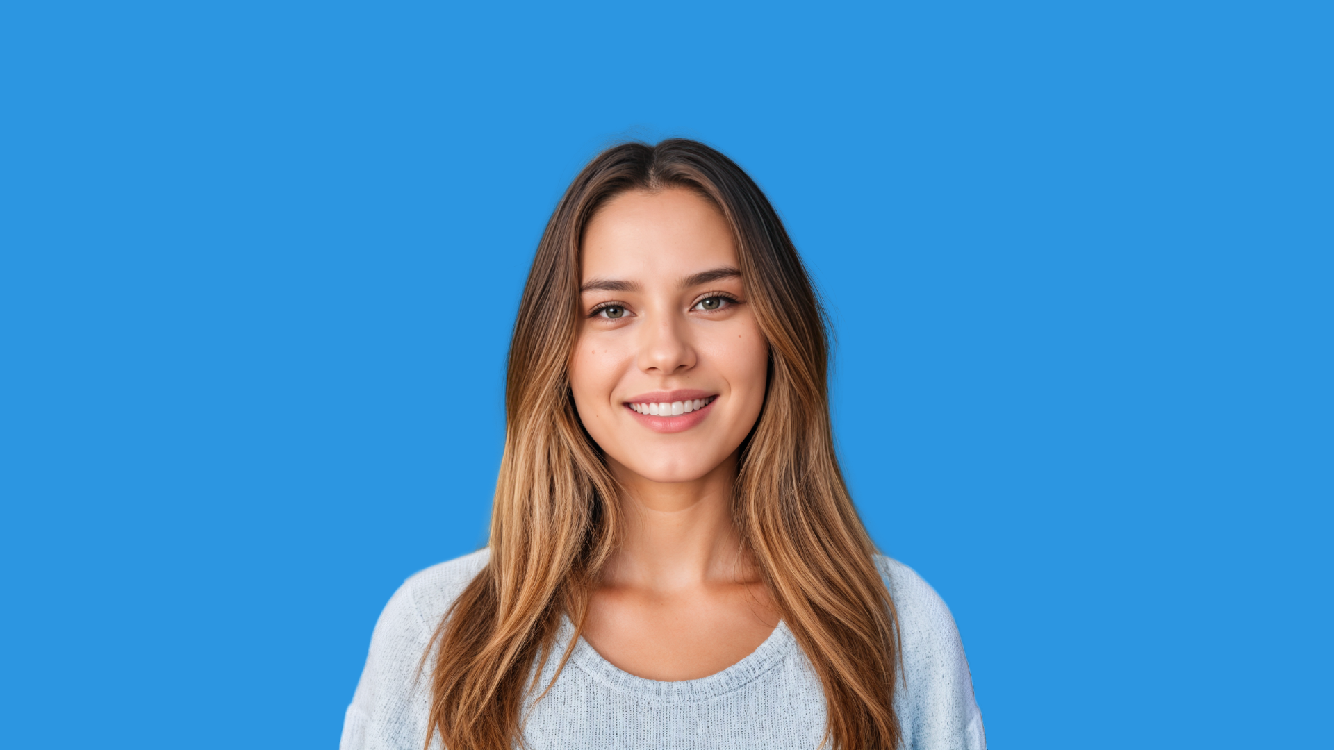 A younger woman with long hair smiles for a picture.